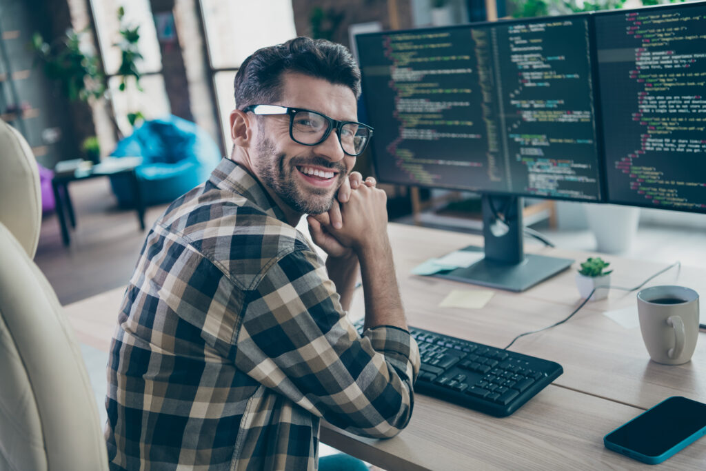 Profile portrait of cheerful intelligent web designer person sit chair create project workplace open space indoors Engineer-led security team